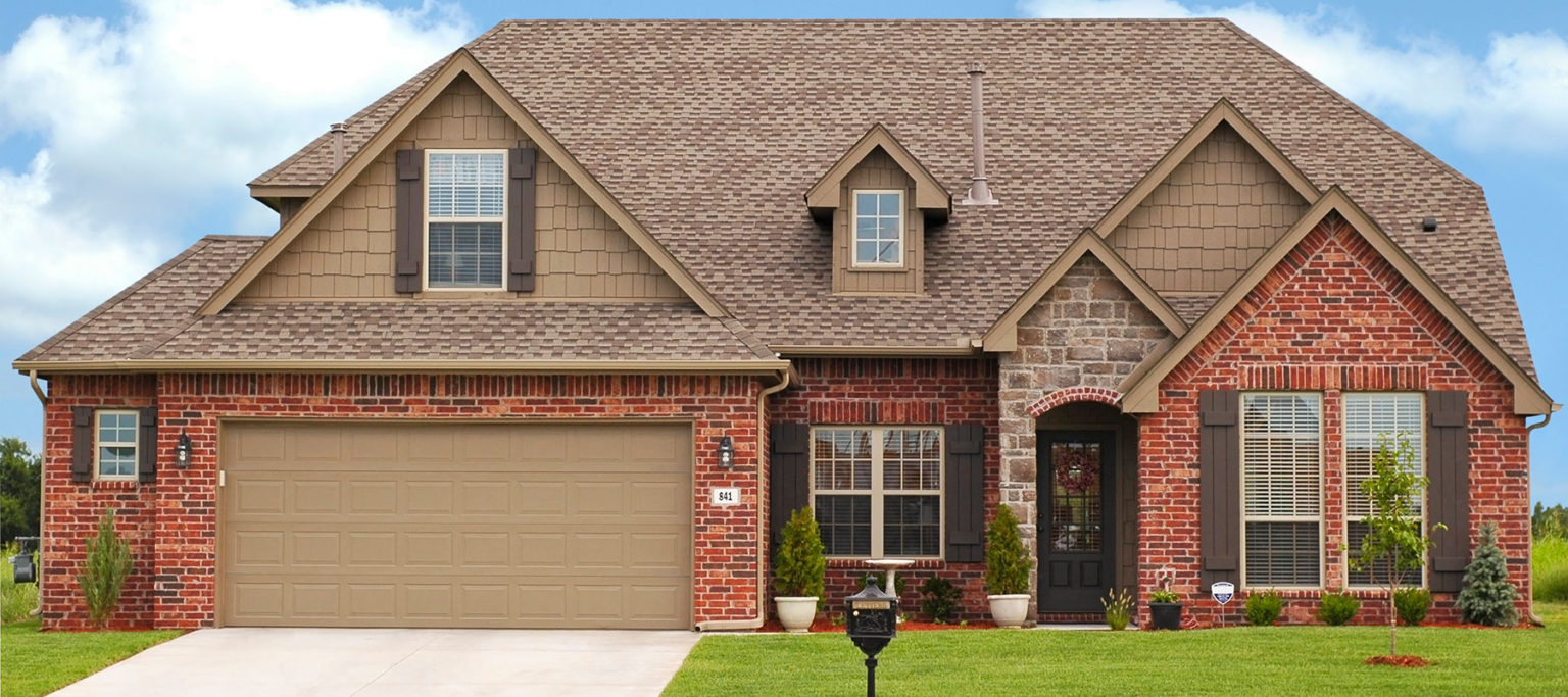 DoorLink 3610 traditional raised panel garage door in sandstone